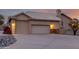 View of a three-car garage and a driveway leading to the house at sunset at 15646 E Sunflower Dr, Fountain Hills, AZ 85268