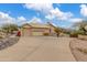 View of a three-car garage and a driveway leading to the house on a sunny day at 15646 E Sunflower Dr, Fountain Hills, AZ 85268