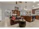 Relaxing living room featuring a large sofa adjacent to the island and the kitchen at 15646 E Sunflower Dr, Fountain Hills, AZ 85268