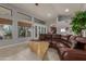 Bright living room featuring tile floors, a large sectional sofa, and seamless access to the outdoor patio at 15646 E Sunflower Dr, Fountain Hills, AZ 85268