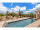 A serene pool area with desert landscaping, fire pit, and desert views under a partly cloudy sky at 15646 E Sunflower Dr, Fountain Hills, AZ 85268