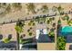 Aerial view of a backyard featuring an outdoor patio set, garden areas, and a shimmering blue pool at 16102 E Glenview Dr, Fountain Hills, AZ 85268