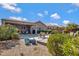 Beautiful backyard featuring a covered patio, lush landscaping, and an inviting outdoor seating area at 16102 E Glenview Dr, Fountain Hills, AZ 85268