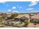 A beautiful backyard with a covered patio, grill, lush landscaping, and a mountain view in the distance at 16102 E Glenview Dr, Fountain Hills, AZ 85268