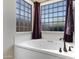 A luxurious soaking tub sits beneath a window providing natural light in this relaxing bathroom space at 16102 E Glenview Dr, Fountain Hills, AZ 85268