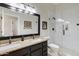 Well-lit bathroom featuring a double vanity with granite countertop and a glass-enclosed shower at 16102 E Glenview Dr, Fountain Hills, AZ 85268