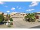 Beautiful home featuring a well-maintained yard with a lush palm tree and a two-car garage at 16102 E Glenview Dr, Fountain Hills, AZ 85268