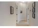 Bright hallway featuring tile floors, white walls and trim, and decorative wall art at 16102 E Glenview Dr, Fountain Hills, AZ 85268