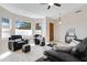 Cozy living room featuring comfortable seating, neutral paint, tile floors, and ample natural light at 16102 E Glenview Dr, Fountain Hills, AZ 85268