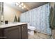 Neutral bathroom with vanity, large mirror, and patterned shower curtain at 16409 S 46Th St, Phoenix, AZ 85048