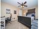 A bedroom that has an office space, ceiling fan and a lamp at 16409 S 46Th St, Phoenix, AZ 85048