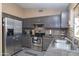 Stylish kitchen with gray cabinets, stainless steel appliances, and granite countertops at 16409 S 46Th St, Phoenix, AZ 85048