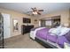 Spacious main bedroom features a ceiling fan, TV, dresser, and an opening to another living space at 16409 S 46Th St, Phoenix, AZ 85048