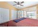 Comfortable bedroom with updated ceiling fan and sliding doors to the exterior at 1647 E Christina St, Casa Grande, AZ 85122