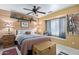 Well decorated bedroom features wooden accent wall, natural light, and ample storage at 1647 E Christina St, Casa Grande, AZ 85122