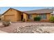 Charming single-story home featuring a neutral-colored exterior, attached garage, and desert landscaping at 1647 E Christina St, Casa Grande, AZ 85122