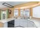 Bright kitchen featuring a stainless sink, white cabinets and countertops, and natural lighting at 1647 E Christina St, Casa Grande, AZ 85122