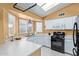 Functional kitchen with white cabinets, black appliances, and plenty of natural light from multiple windows at 1647 E Christina St, Casa Grande, AZ 85122