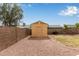 A backyard storage shed next to the brick wall provides additional storage space at 1647 E Christina St, Casa Grande, AZ 85122