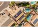 Overhead shot of an upscale home with solar panels on the roof and a luxurious backyard featuring a large swimming pool at 17470 W Gelding Dr, Surprise, AZ 85388