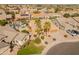 Aerial view of a well-kept home with lush landscaping and mature palm trees in a desirable suburban neighborhood at 17470 W Gelding Dr, Surprise, AZ 85388