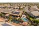 Aerial shot of a home with solar panels and a stunning backyard oasis featuring a private pool and patio area at 17470 W Gelding Dr, Surprise, AZ 85388