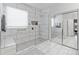 Bright bathroom showcasing a glass-enclosed shower with modern fixtures and marble tile at 17470 W Gelding Dr, Surprise, AZ 85388