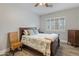 Cozy bedroom with wood-look floors, neutral walls, and a large window at 17470 W Gelding Dr, Surprise, AZ 85388