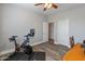 Bedroom featuring a ceiling fan, wood floors and neutral colored walls at 17470 W Gelding Dr, Surprise, AZ 85388