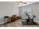 Functional bedroom with a desk, exercise bike, and ample natural light at 17470 W Gelding Dr, Surprise, AZ 85388