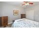 Bedroom with wood flooring and a ceiling fan, providing a comfortable retreat at 17470 W Gelding Dr, Surprise, AZ 85388