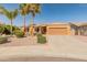 Inviting single-story home with a well-maintained lawn and desert landscaping at 17470 W Gelding Dr, Surprise, AZ 85388