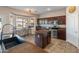 Stylish kitchen boasts granite counters and a cozy breakfast nook by the window at 17470 W Gelding Dr, Surprise, AZ 85388