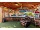 Outdoor covered lounge area with bar and seating overlooking the pool at 17470 W Gelding Dr, Surprise, AZ 85388