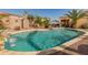 Backyard with a private pool, lush landscaping, and outdoor seating area at 17470 W Gelding Dr, Surprise, AZ 85388