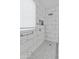 Beautiful bathroom with marble tile, a rainfall showerhead, and a frameless glass enclosure at 17470 W Gelding Dr, Surprise, AZ 85388