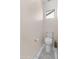 Neutral colored toilet room offering a standard toilet and small window at 17470 W Gelding Dr, Surprise, AZ 85388