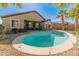 Inviting backyard pool with desert landscaping and patio seating; perfect for entertaining at 18026 W Carmen Dr, Surprise, AZ 85388