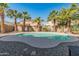 Backyard with a private pool, desert landscaping, and mature palm trees at 18026 W Carmen Dr, Surprise, AZ 85388