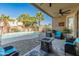 Spacious covered patio with a view of the pool, seating, and desert landscaping at 18026 W Carmen Dr, Surprise, AZ 85388