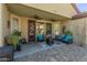 Inviting covered patio with ceiling fans offers a relaxing view of the backyard at 18026 W Carmen Dr, Surprise, AZ 85388