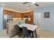 Open kitchen and dining area, with stainless steel appliances, granite countertops, and a modern dining set at 18026 W Carmen Dr, Surprise, AZ 85388