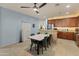 Bright kitchen and dining area with tiled floors and modern furniture, perfect for Gathering meals at 18026 W Carmen Dr, Surprise, AZ 85388