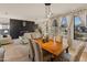 Inviting dining room boasts a modern light fixture and views of the fireplace feature at 18026 W Carmen Dr, Surprise, AZ 85388