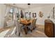 Bright dining area showcases a wooden table with seating for six and large sunlit windows at 18026 W Carmen Dr, Surprise, AZ 85388