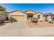 Inviting single-story home features a two-car garage and a well-maintained desert landscape at 18026 W Carmen Dr, Surprise, AZ 85388