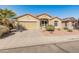 Charming single-story home featuring a desert landscape, a two-car garage, and a well-maintained lawn at 18026 W Carmen Dr, Surprise, AZ 85388