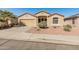 Charming single-story home featuring a desert landscape, a two-car garage, and a well-maintained lawn at 18026 W Carmen Dr, Surprise, AZ 85388