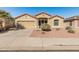 Charming single-story home featuring a desert landscape, a two-car garage, and a well-maintained lawn at 18026 W Carmen Dr, Surprise, AZ 85388