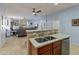 Bright kitchen featuring a double sink and stainless steel dishwasher with an open layout to the living area at 18026 W Carmen Dr, Surprise, AZ 85388